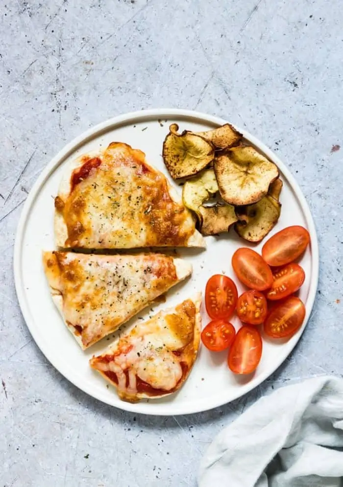 A plate of food with a slice of pizza