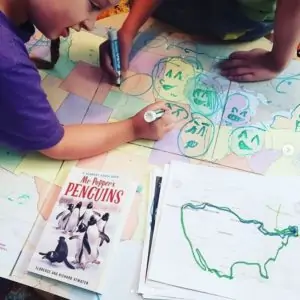 kids coloring a map of the United States of America with markers