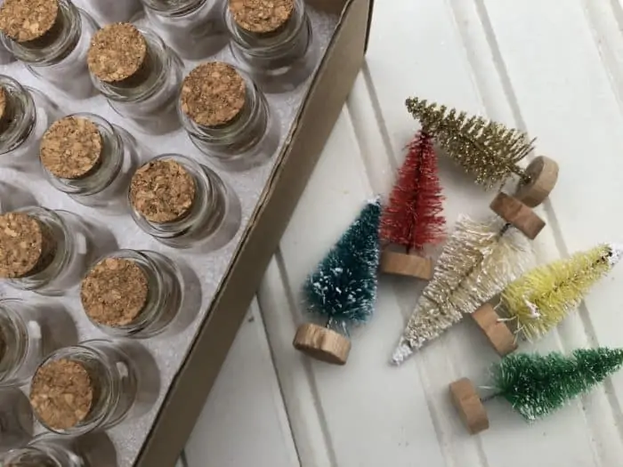 image of jars on a table with tiny Christmas tree decorations on the floor