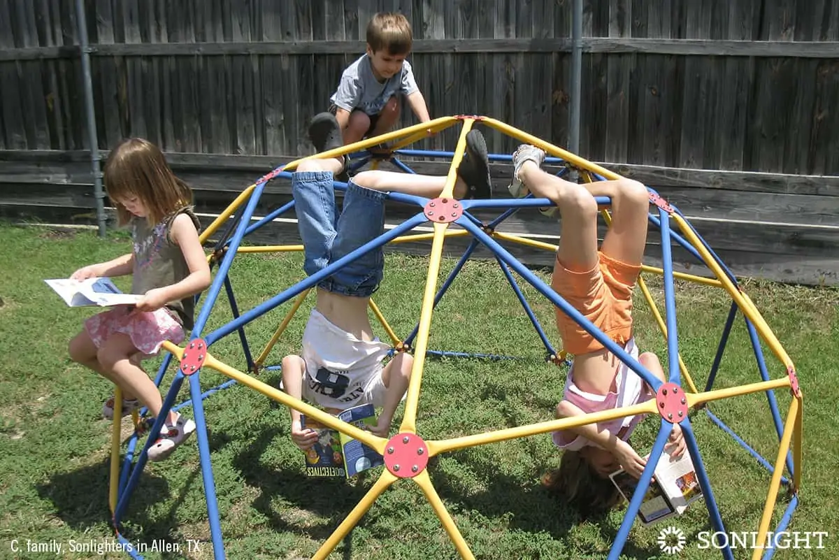 kids playing together outside on playground equipment