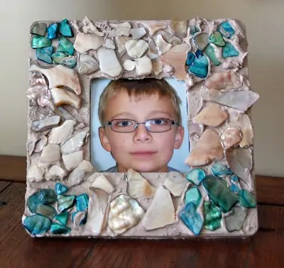 mosaic frame with a picture of a child\'s face in the center