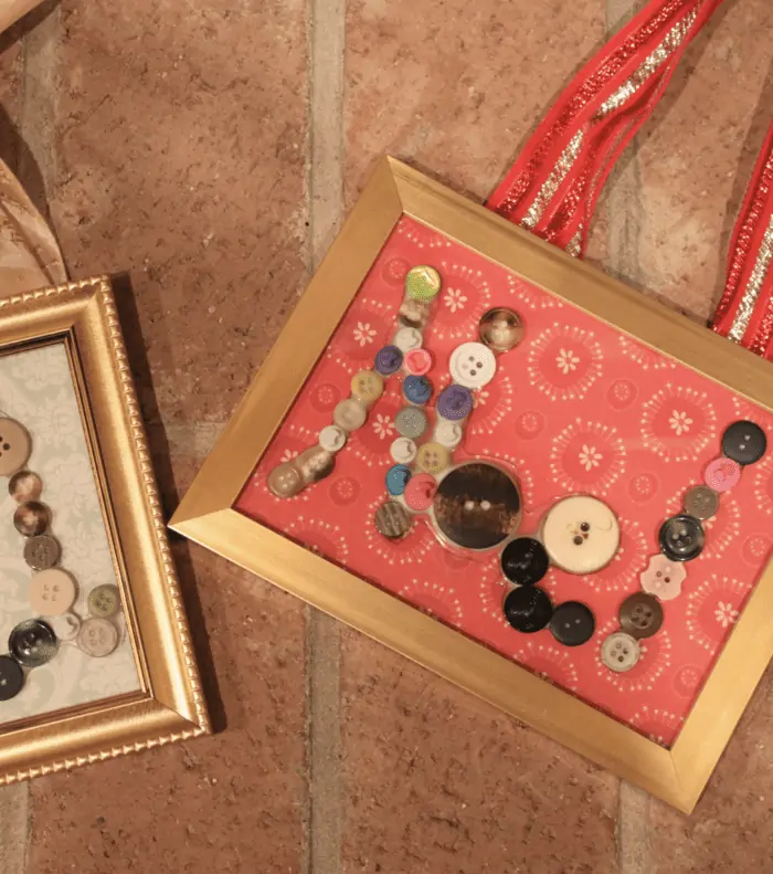 Button art on picture frames with a brick background