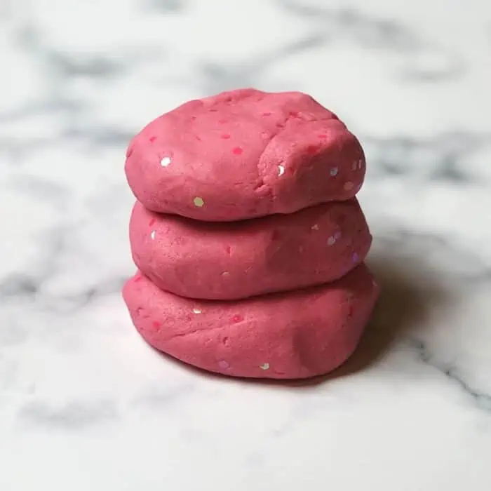 glitter playdough stacked on top of each other. 