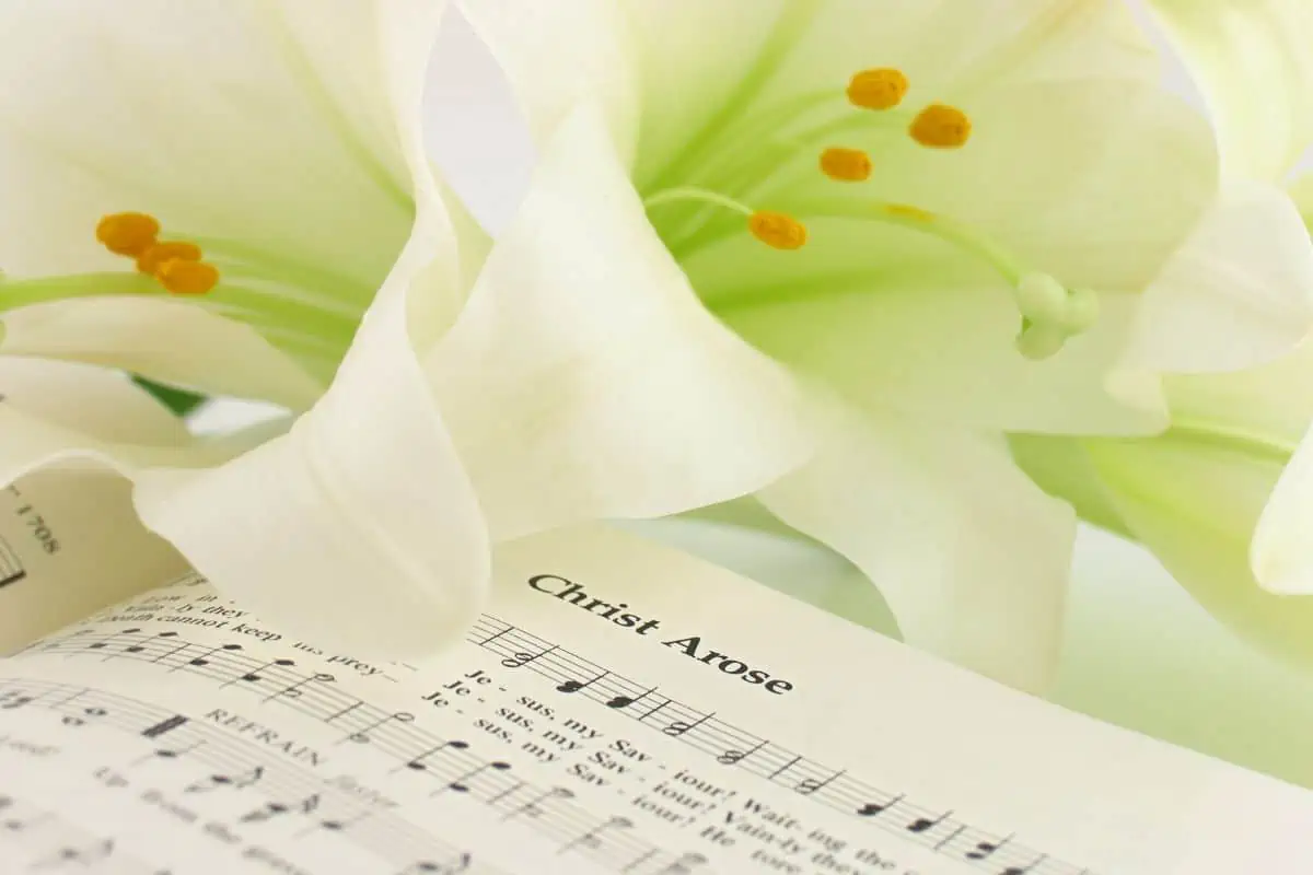 best easter hymns showing christ arose hymn page with an easter lily on top of it