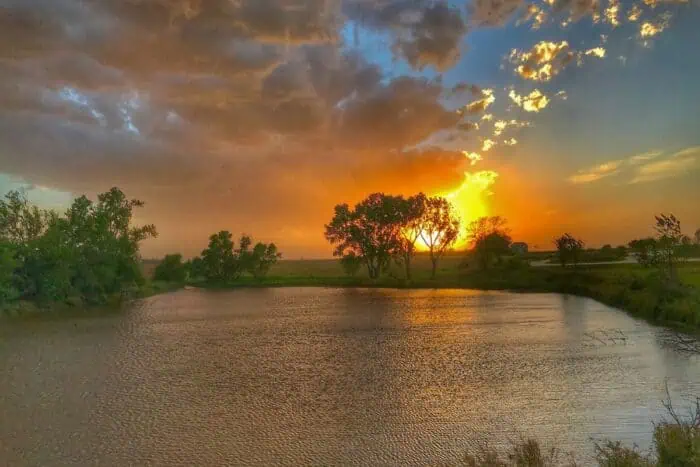 sunset over a lake at herbert hoover historic site