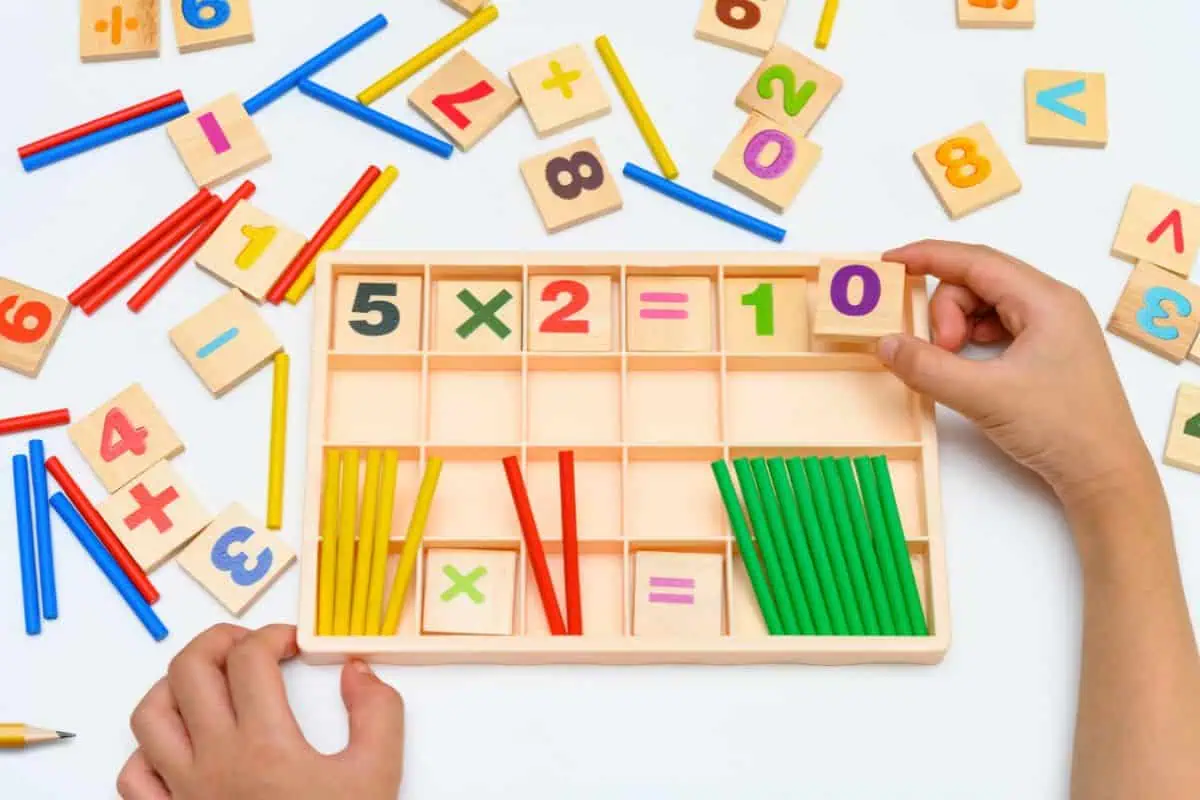 5 times table fact with manipulatives on a table